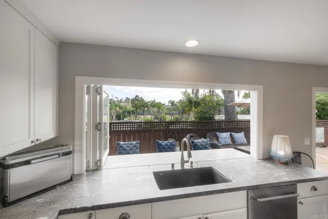 a kitchen with a sink and large window