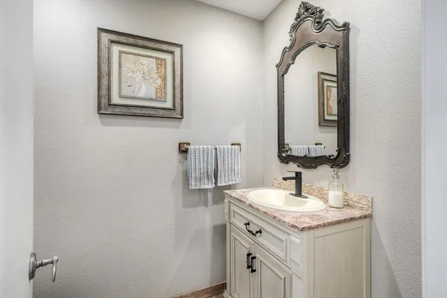 a bathroom with a double vanity sink and a mirror