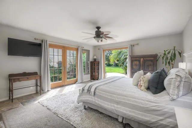 a bedroom with a bed and a television