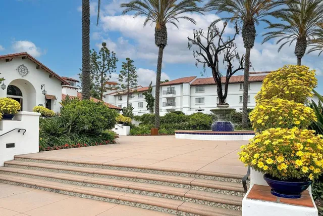 a front view of a house with a garden and a yard