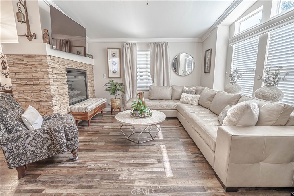 a living room with furniture a fireplace and a large window
