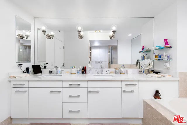 a bathroom with a sink vanity and mirror