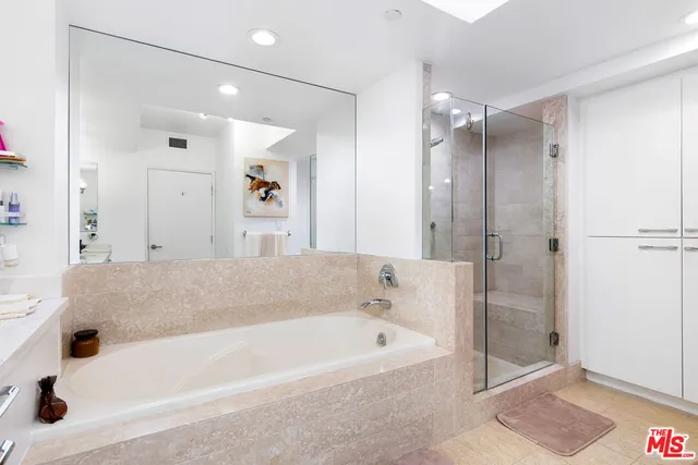a bathroom with a bathtub and a shower