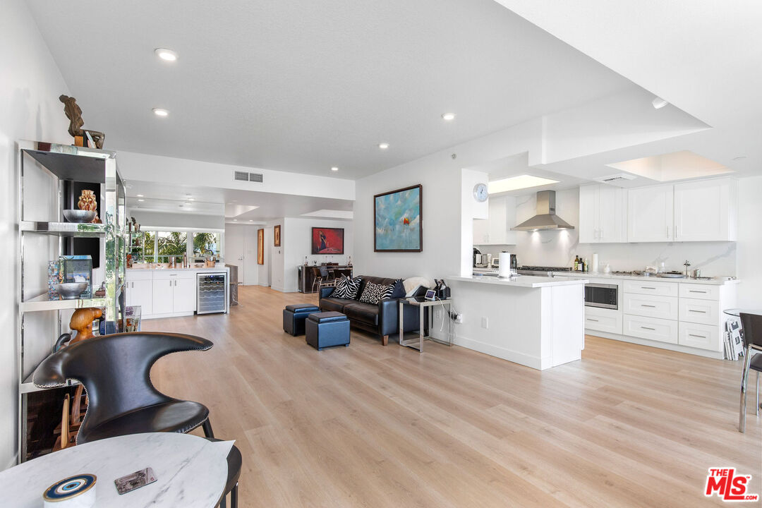 13600 Marina Pointe Drive, Unit 401 Marina del Rey, CA 90292 - Photo 7 of 41 a large white kitchen with lots of counter top space and stainless steel appliances