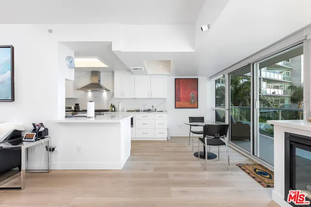 a kitchen with a sink cabinets and dining table chair