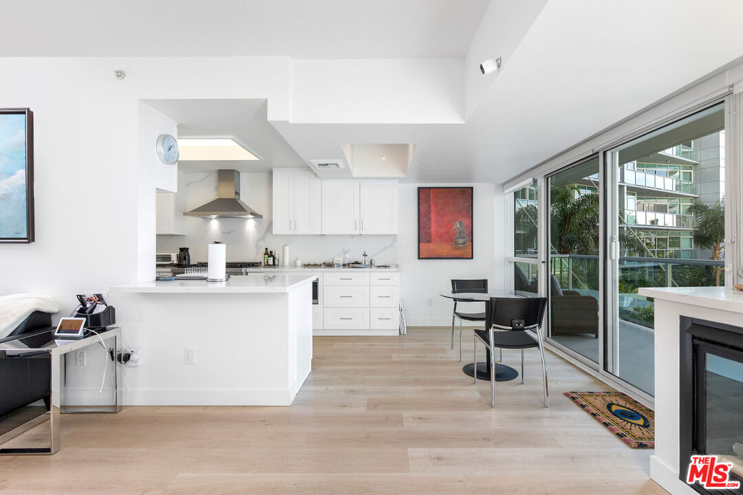 13600 Marina Pointe Drive, Unit 401 Marina del Rey, CA 90292 - Photo 8 of 41 a kitchen with a sink cabinets and dining table chair