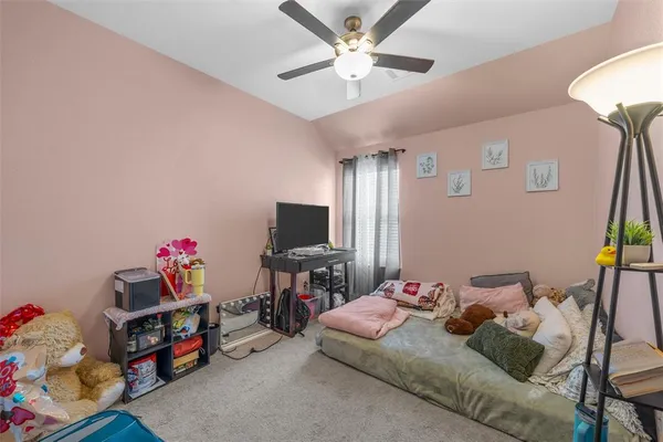 a bedroom with furniture and a flat screen tv