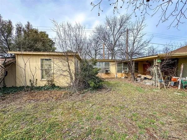 a backyard of a house with table and chairs
