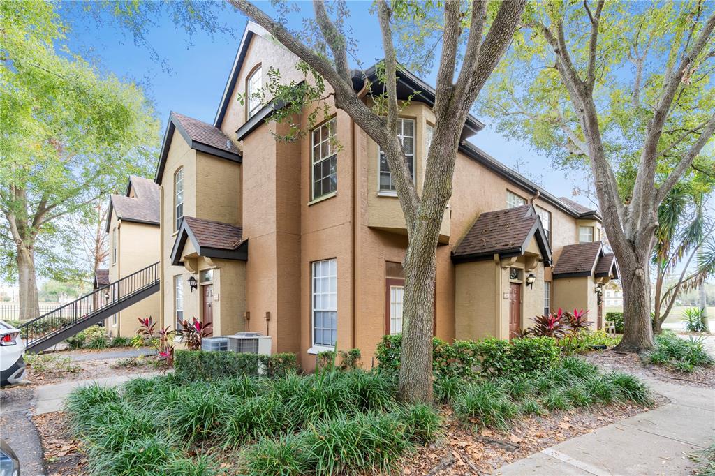 6392 Raleigh Street, Unit 2804 Orlando, FL 32835 - Photo 1 of 1 a front view of a house with a tree