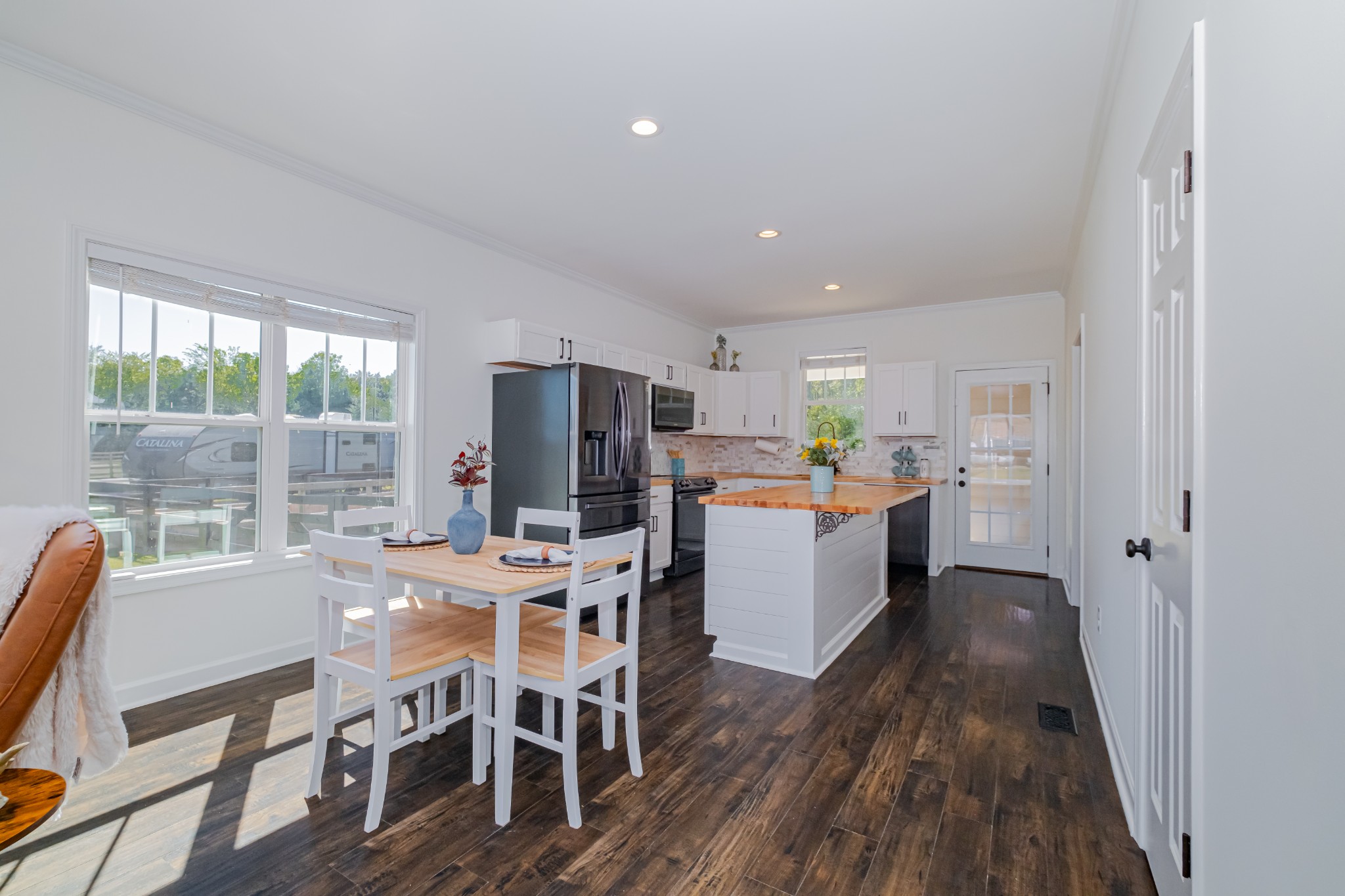 4781 Brookhollow Road Chapel Hill, TN 37034 - Photo 16 of 57 a kitchen with a dining table chairs and refrigerator
