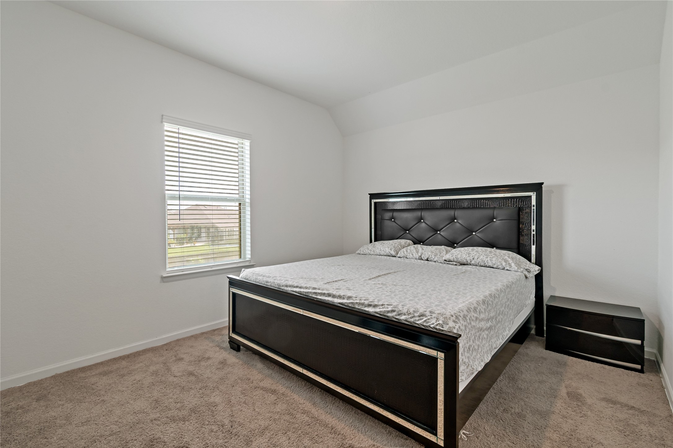 14010 Hartford Heights Way Rosharon, TX 77583 - Photo 22 of 30 a bed sitting in a bedroom next to a window