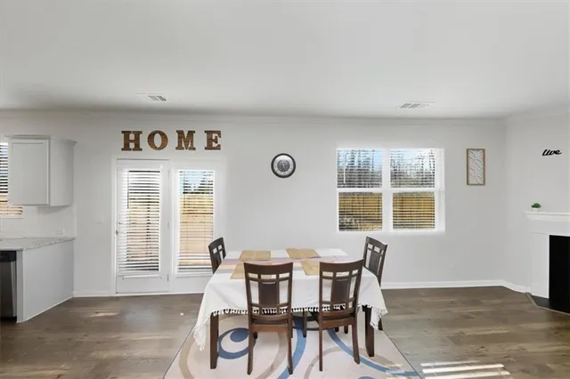 a view of a dining room with furniture and windows