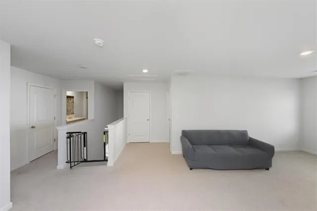 a living room with furniture and hallway