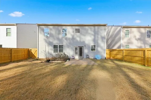 a view of a house with a backyard and a garage