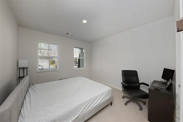 a bedroom with a workspace