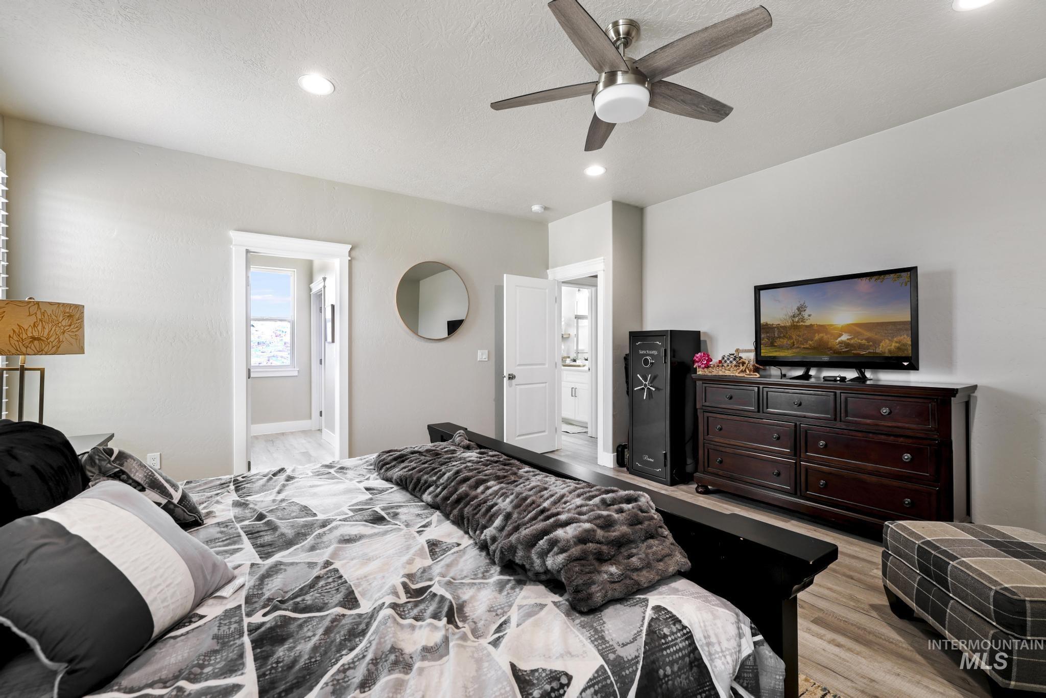 758 Cedar Crk Road Rogerson, ID 83302 - Photo 20 of 50 Light-toned walls complement wood-finish flooring in this room featuring recessed lighting and a ceiling fan