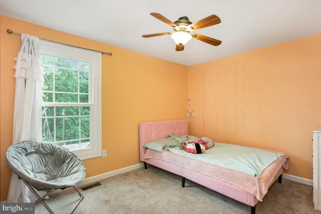 a bedroom with two beds and a window