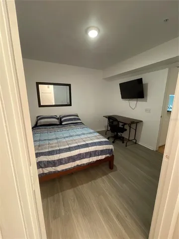 a bedroom with a bed and flat screen tv