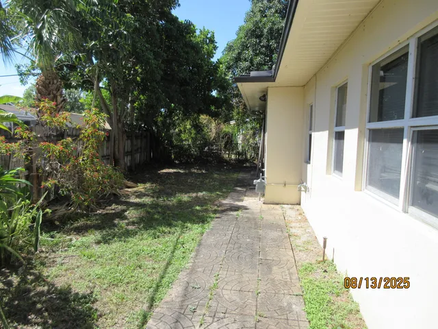 a view of a pathway of a house with a yard