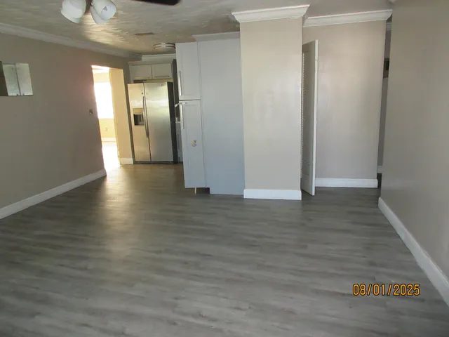 a view of a hallway with wooden floor