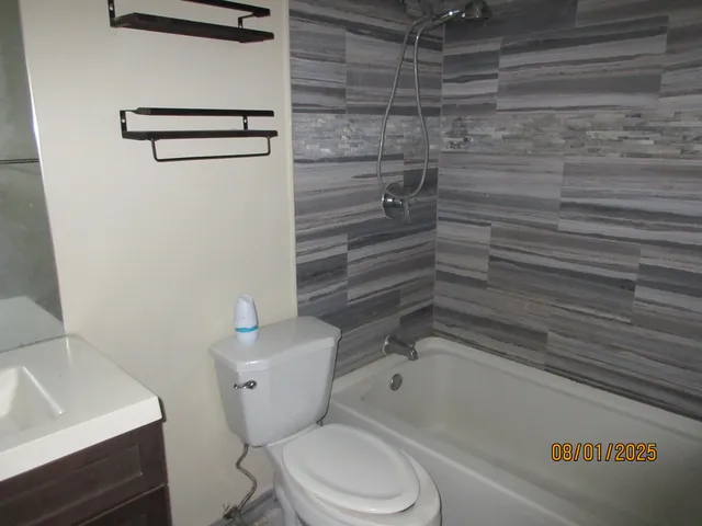 a bathroom with a toilet and a sink