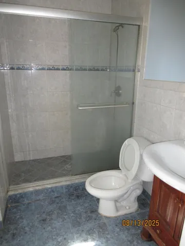 a white toilet sitting next to a bathroom sink