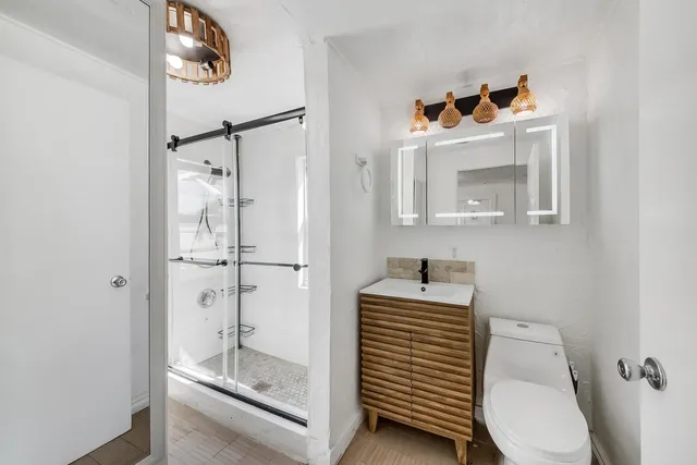 a bathroom with a sink toilet and shower