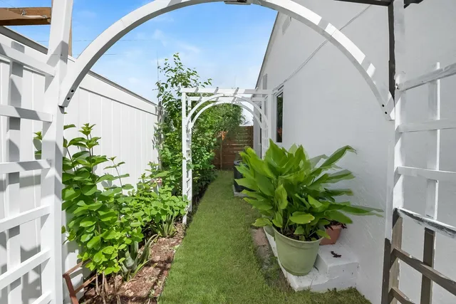 a backyard of a house with barbeque oven table and chairs