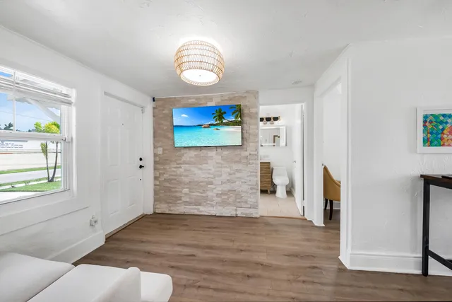 a view of a livingroom with wooden floor and window