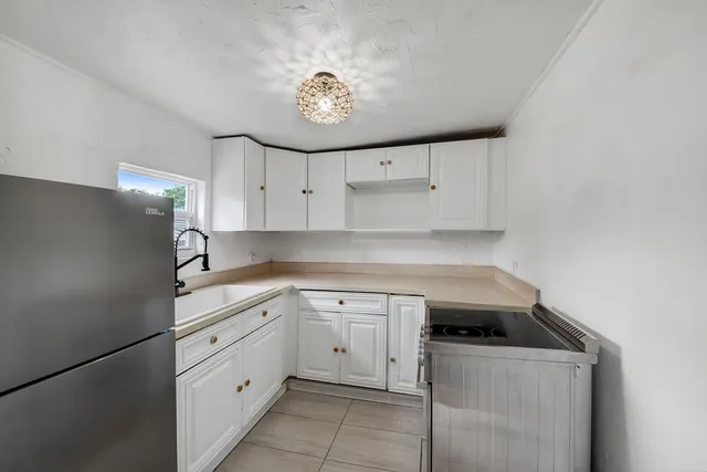 a kitchen with cabinets stainless steel appliances and a counter space