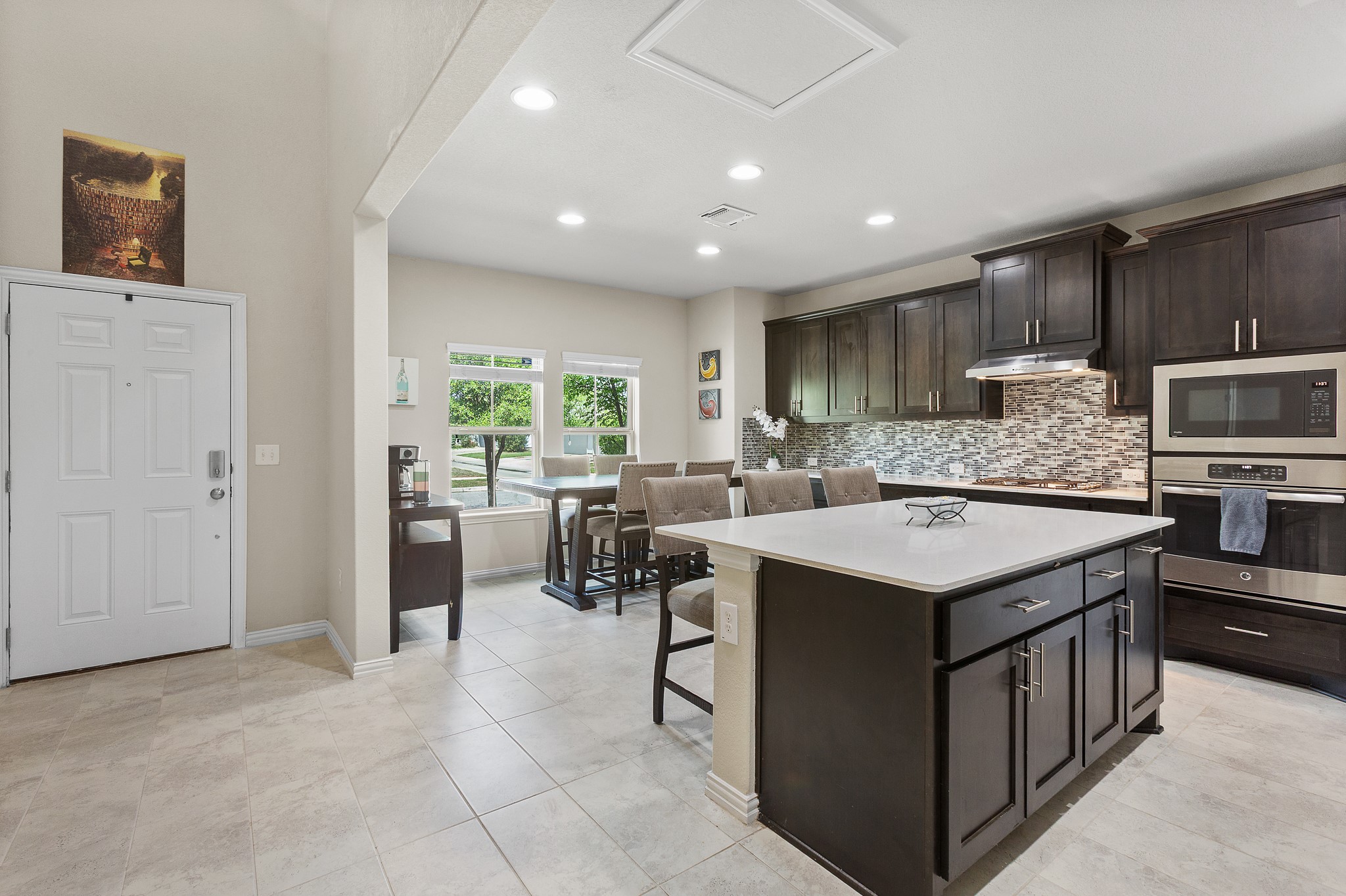 8709 Slater Drive Austin, TX 78747 - Photo 6 of 36 a kitchen with a sink a counter top space stainless steel appliances and cabinets