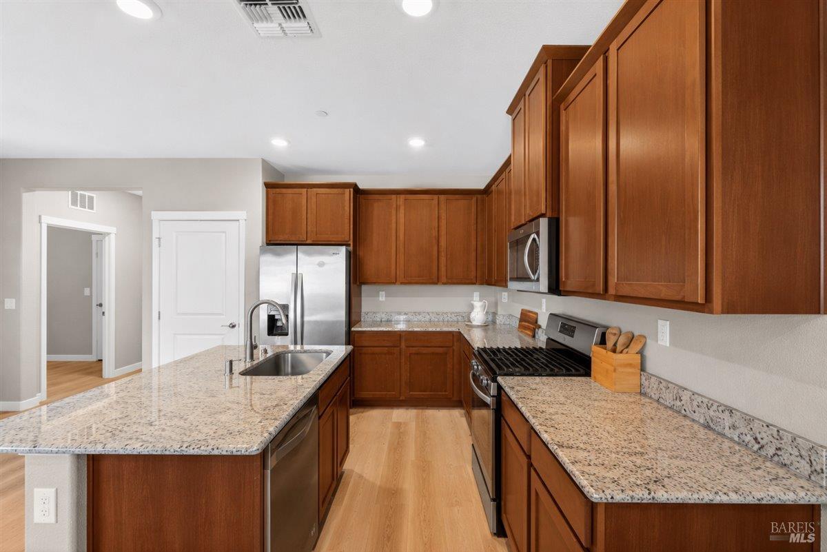 2275 Revival Lane Rio Vista, CA 94571 - Photo 8 of 31 a kitchen with granite countertop stainless steel appliances a sink a counter top space and cabinets