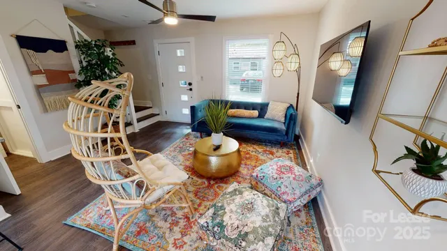 a living room with furniture and a mirror