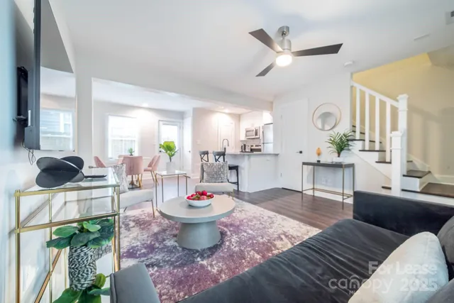 a living room with furniture a rug and a chandelier