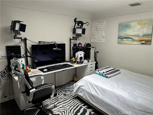 a bed room with a bed and a television