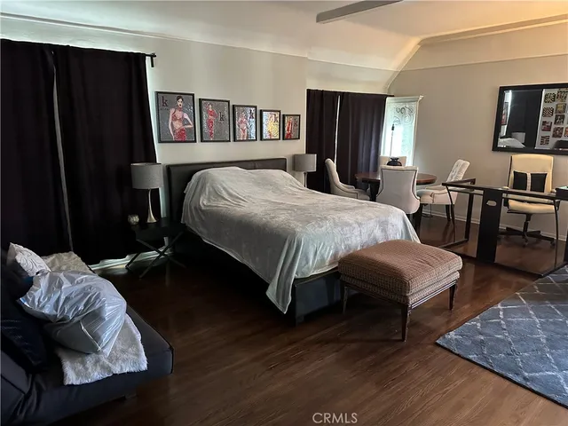a bedroom with bed and a night stand