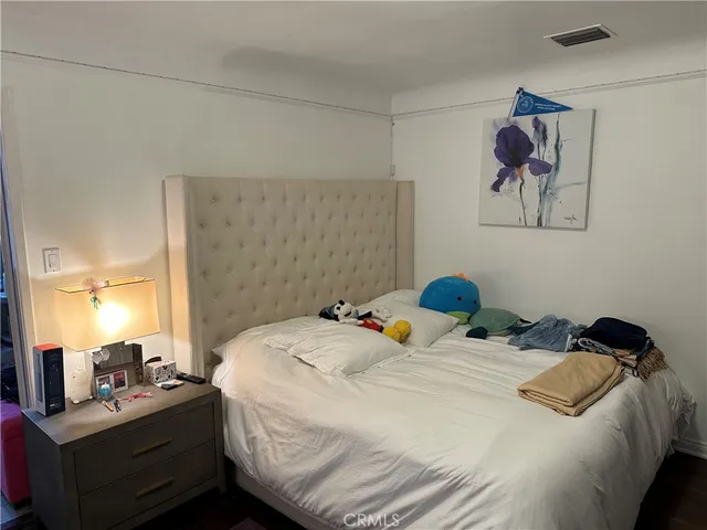 a bedroom with a bed and a lamp