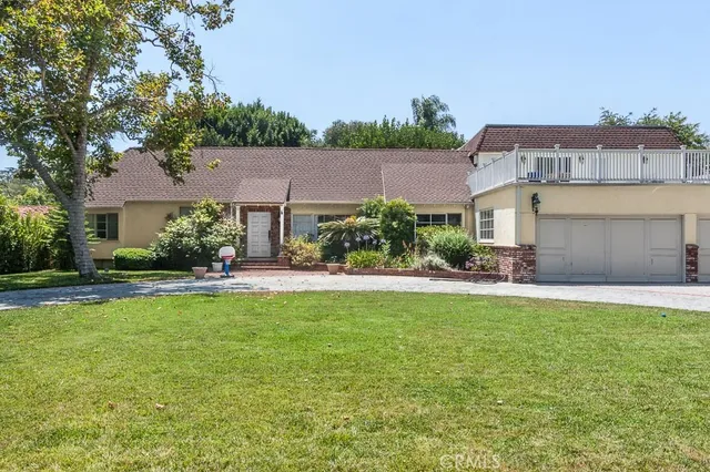 a front view of a house with a garden and plants