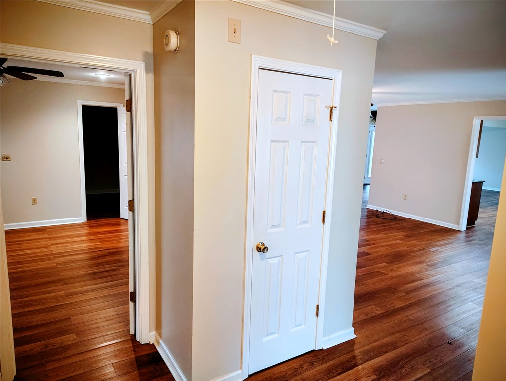 Bright interior spaces flow seamlessly, revealing rich hardwood floors.