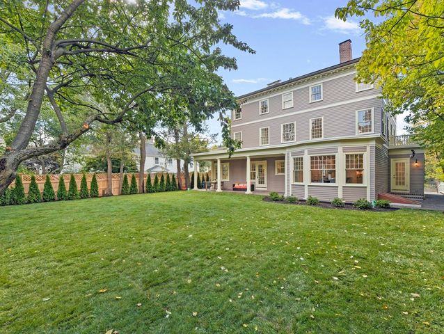 a view of a big yard with a house in the background