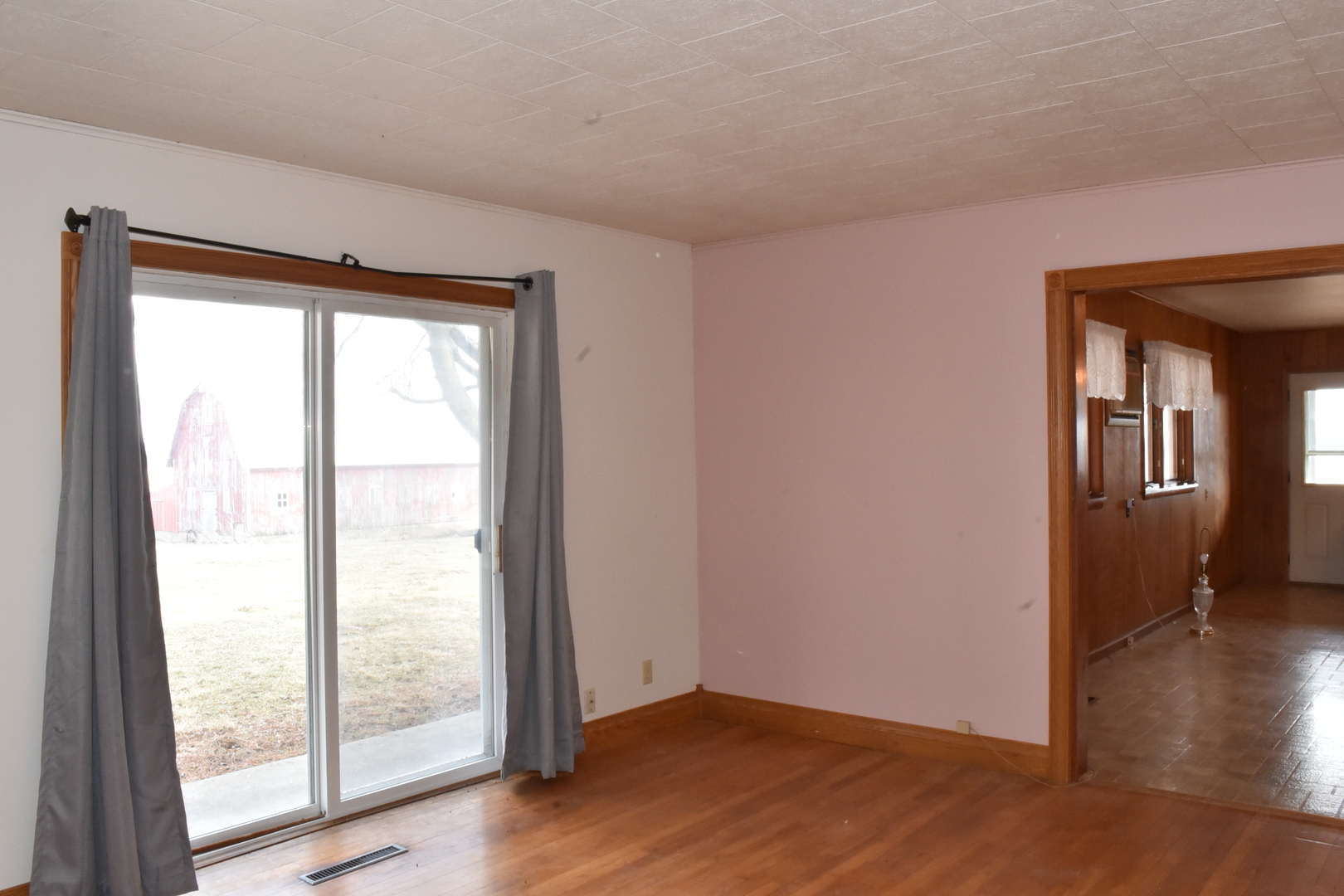 13801 Lister Road Morrison, IL 61270 - Photo 7 of 30 a view of an empty room with wooden floor and a window