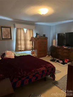 a bedroom with a bed and a television