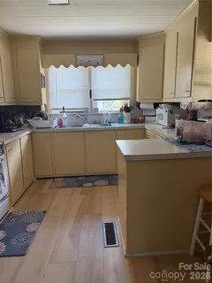 a kitchen with granite countertop a sink and a stove top oven