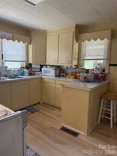 a kitchen with sink and cabinets