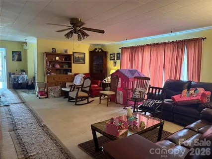 a view of a livingroom with furniture and a large window