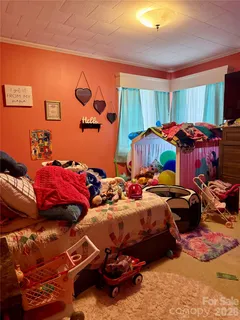 a bedroom with bed and a window