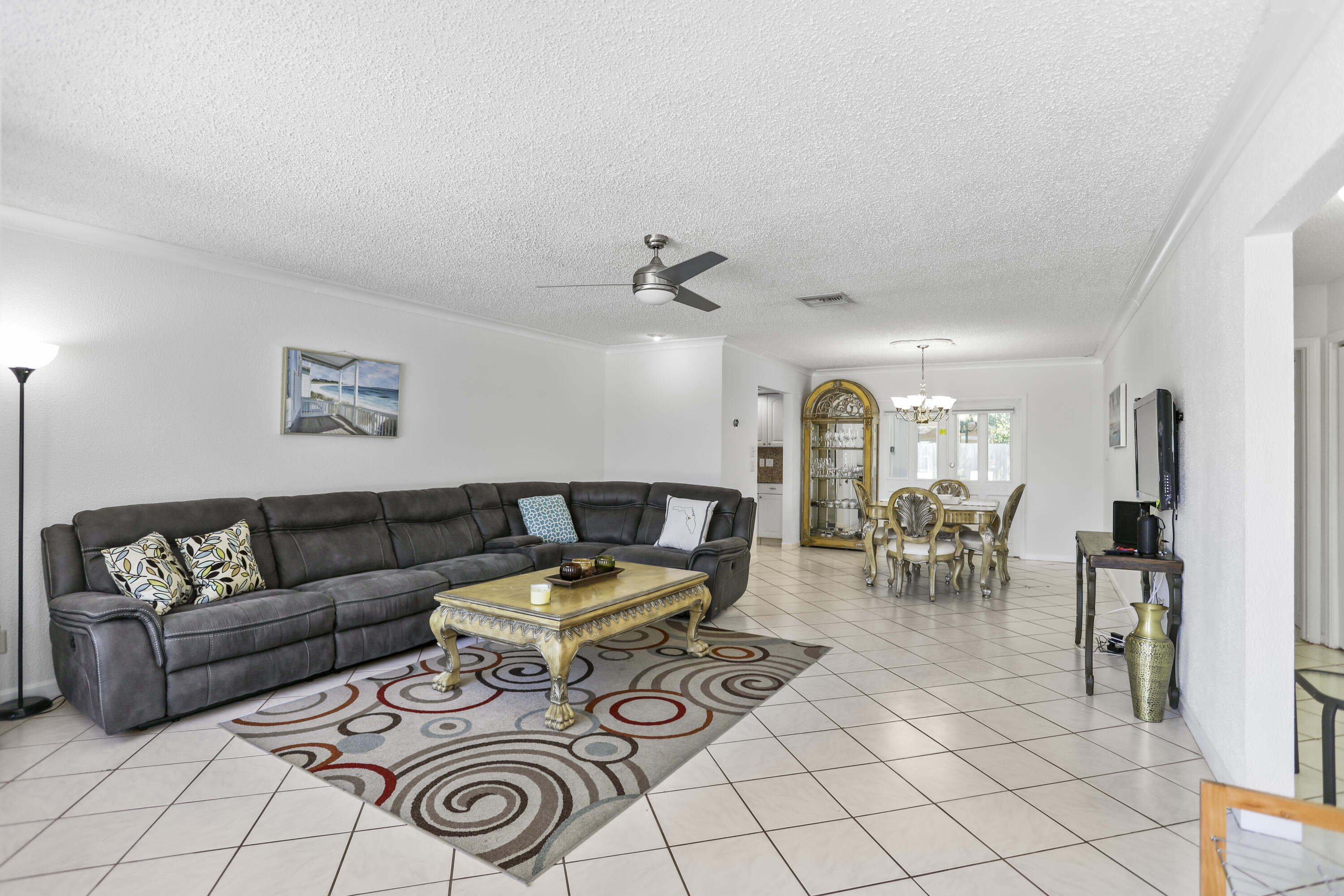 22682 Southwest 65th Avenue Boca Raton, FL 33428 - Photo 13 of 58 a living room with furniture a rug and gym equipment
