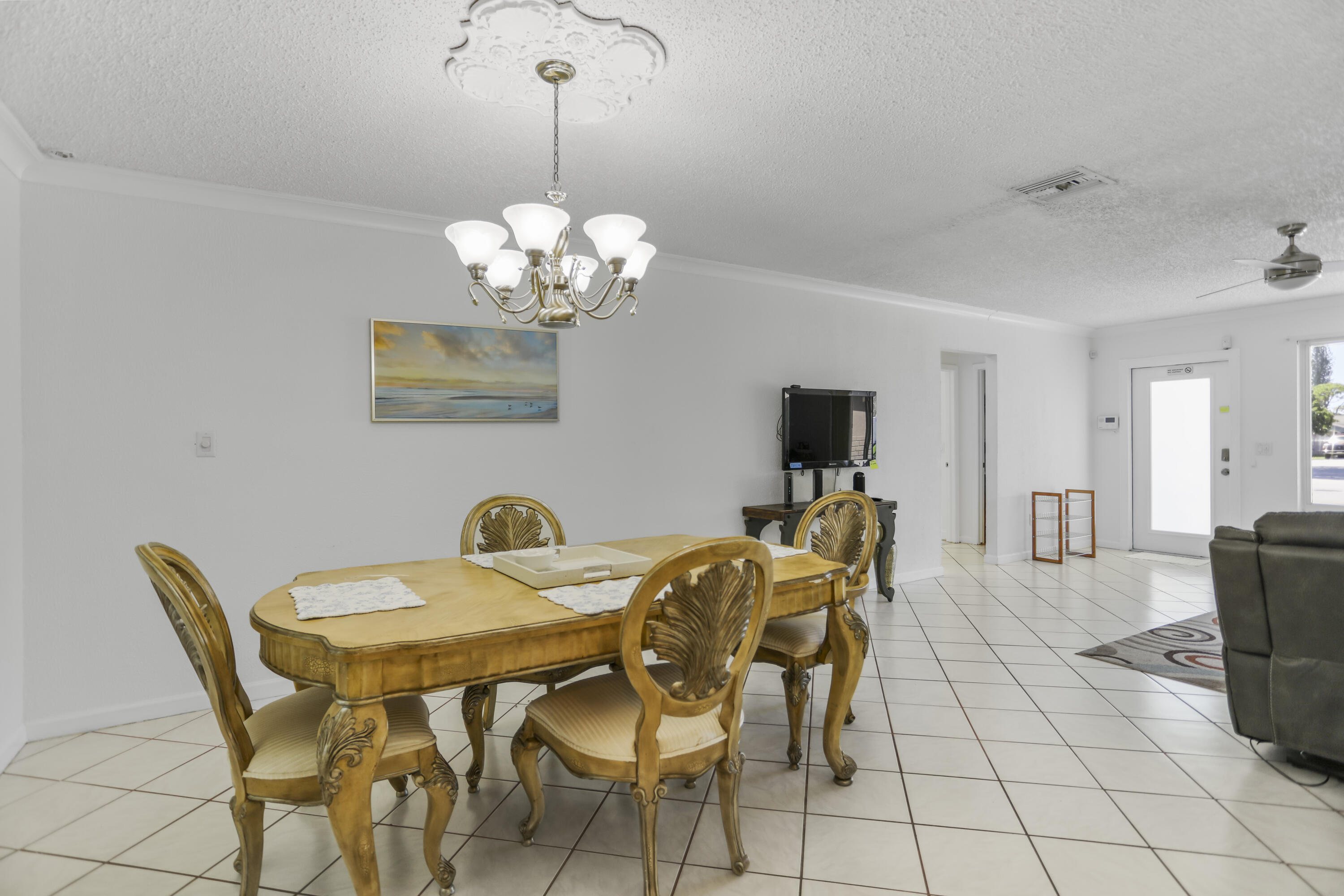 22682 Southwest 65th Avenue Boca Raton, FL 33428 - Photo 15 of 58 a view of a dining room with furniture and chandelier