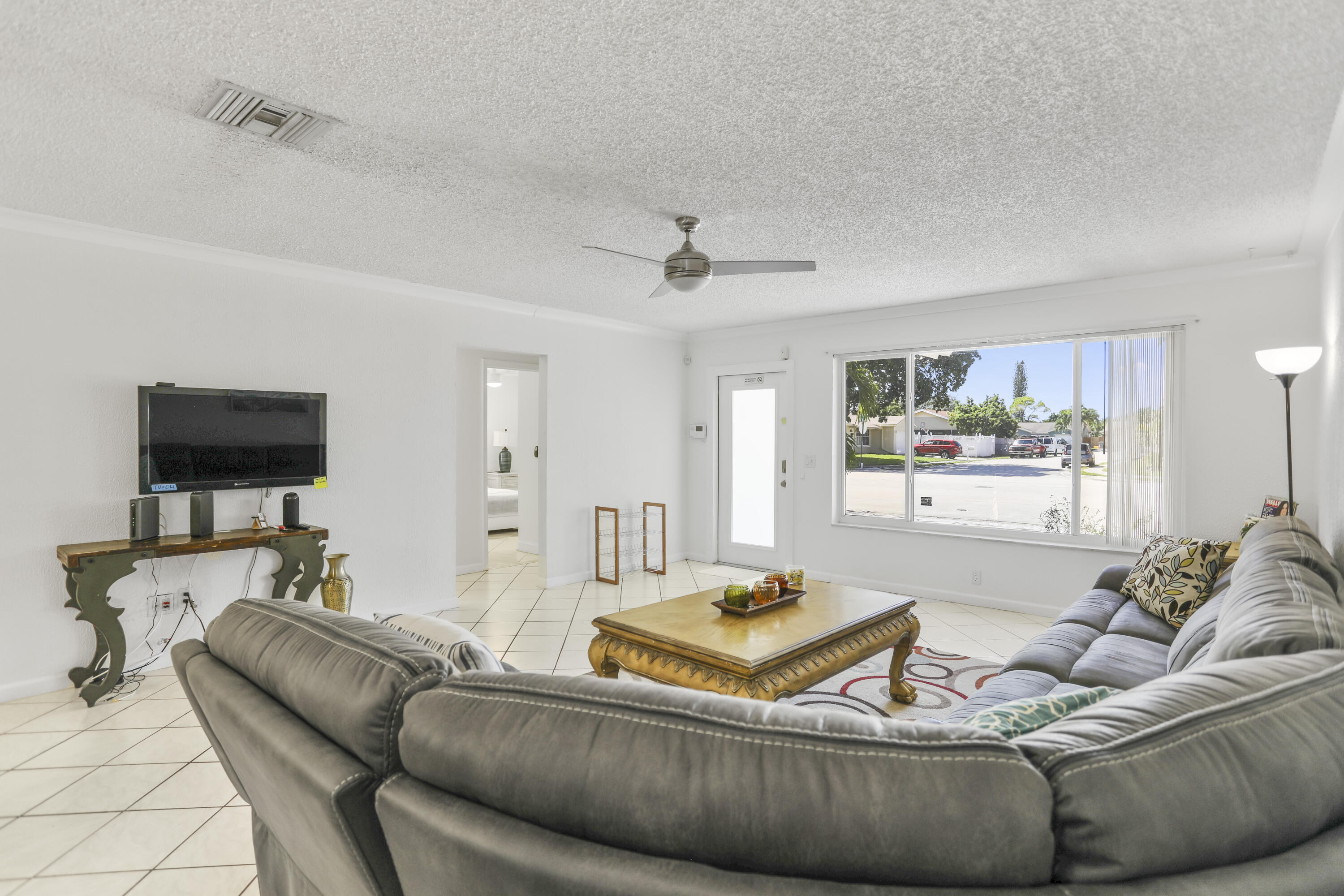22682 Southwest 65th Avenue Boca Raton, FL 33428 - Photo 17 of 58 a living room with furniture and a flat screen tv