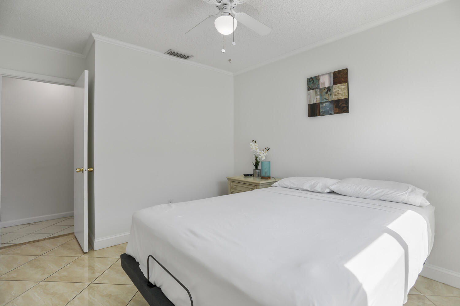 22682 Southwest 65th Avenue Boca Raton, FL 33428 - Photo 26 of 58 a bedroom with a bed and a chandelier fan